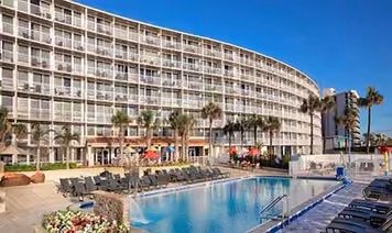 Pool and oceanfront resort building at Holiday Inn Resort Daytona Beach in Florida